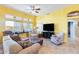 Spacious living room with a ceiling fan, tile floors, and lots of natural light at 15840 W Falcon Ridge Dr, Sun City West, AZ 85375