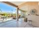 Covered patio area with seating and a decorative sunburst wall ornament at 15840 W Falcon Ridge Dr, Sun City West, AZ 85375