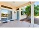 Inviting patio area featuring a lush tree providing shade, complemented by easy access through sliding glass doors at 15840 W Falcon Ridge Dr, Sun City West, AZ 85375