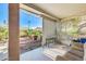 View of the covered patio overlooking a well-maintained backyard, creating a serene outdoor living space at 15840 W Falcon Ridge Dr, Sun City West, AZ 85375