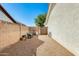 Gravel-covered side yard, enclosed by a brick fence and the exterior of the home at 15840 W Falcon Ridge Dr, Sun City West, AZ 85375