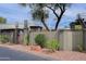 Exterior view of the property featuring a block fence, landscaping, and trees at 16807 E Gunsight Dr # B18, Fountain Hills, AZ 85268