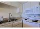 Bright kitchen with stainless steel sink, white appliances and modern microwave at 16807 E Gunsight Dr # B18, Fountain Hills, AZ 85268