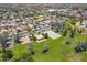 Aerial shot shows the community park with picnic ramada, green space, and basketball court surrounded by homes at 16939 W Marconi Ave, Surprise, AZ 85388