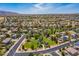 Aerial view shows a neighborhood with a community park offering green space, trees, and walking paths for residents at 16939 W Marconi Ave, Surprise, AZ 85388