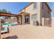 This cozy backyard features a pool, covered patio, and low maintenance landscaping at 16939 W Marconi Ave, Surprise, AZ 85388