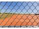 Baseball field seen through chain-link fence, revealing meticulously groomed field at 16939 W Marconi Ave, Surprise, AZ 85388