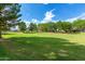 Lush green community space with mature trees providing shade, perfect for relaxation and outdoor enjoyment at 16939 W Marconi Ave, Surprise, AZ 85388