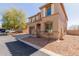 Charming two-story home featuring a two-car garage, arched entry, and desert landscaping at 16939 W Marconi Ave, Surprise, AZ 85388