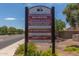 Community HOA sign displaying meeting times, website, contact information, and upcoming garage sale event at 16939 W Marconi Ave, Surprise, AZ 85388