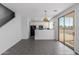 Eat-in kitchen with sleek black appliances, white cabinets, and gray tile flooring at 16939 W Marconi Ave, Surprise, AZ 85388