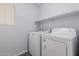 Laundry room featuring a washer and dryer along with a shelving unit at 16939 W Marconi Ave, Surprise, AZ 85388