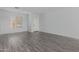 Bright living room with light-colored walls, laminate wood floors and a front door at 16939 W Marconi Ave, Surprise, AZ 85388