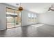 Bright living room with a fan, sliding glass doors to the backyard and view of a pool at 16939 W Marconi Ave, Surprise, AZ 85388