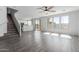 Bright living room featuring an open layout with laminate floors, staircase and lots of natural light at 16939 W Marconi Ave, Surprise, AZ 85388