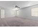 Large main bedroom with carpet, ceiling fan, large windows and closet space at 16939 W Marconi Ave, Surprise, AZ 85388