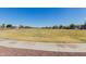 A wide shot of the community park with green grass and walking paths at 16939 W Marconi Ave, Surprise, AZ 85388