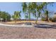 Inviting park area featuring shaded benches beneath mature trees at 16939 W Marconi Ave, Surprise, AZ 85388