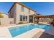 A stunning view of the pool and home from the backyard with covered patio at 16939 W Marconi Ave, Surprise, AZ 85388