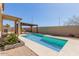 The backyard features a pool with a modern pergola and patio seating at 16939 W Marconi Ave, Surprise, AZ 85388