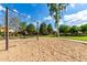 A community swing set and sand pit area are surrounded by mature trees and lush landscaping at 16939 W Marconi Ave, Surprise, AZ 85388