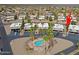 Aerial view showcases the community pool and surrounding two-story condos with mature palm trees, providing a lush desert oasis at 17031 E Calle Del Oro -- # B, Fountain Hills, AZ 85268