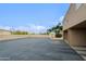 Large paved parking area outside a multi-story building against a backdrop of trees and a sports field at 17056 E Calle Del Oro Dr # B, Fountain Hills, AZ 85268