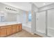 Primary bathroom featuring dual sinks, a soaking tub, and glass-enclosed shower at 1715 E Branham Ln, Phoenix, AZ 85042