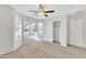 Light-filled bedroom boasting a ceiling fan, a window with a view, and ample closet space at 1715 E Branham Ln, Phoenix, AZ 85042