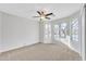 Bright bedroom featuring a ceiling fan and large windows offering plenty of natural light at 1715 E Branham Ln, Phoenix, AZ 85042