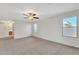 Light-filled bedroom with carpet, a ceiling fan, and neutral paint at 1715 E Branham Ln, Phoenix, AZ 85042