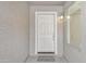 Close-up of a white front door with welcome mat and exterior lighting fixture at 1715 E Branham Ln, Phoenix, AZ 85042