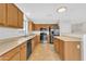 Well-equipped kitchen featuring wood cabinets, stainless steel appliances, and a breakfast bar at 1715 E Branham Ln, Phoenix, AZ 85042