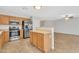 Well-lit kitchen featuring stainless steel appliances, tile flooring, and wooden cabinets at 1715 E Branham Ln, Phoenix, AZ 85042