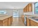 Bright kitchen featuring wood cabinets, stainless steel appliances, and a large sliding glass door to the backyard at 1715 E Branham Ln, Phoenix, AZ 85042