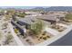 An aerial shot showing a well-manicured home with mountain views, desert landscaping, and a fenced yard at 17796 W Sandy Rd, Goodyear, AZ 85338