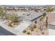 An aerial view shows the roof, desert landscaping, and privacy fencing of this single-Gathering home at 17796 W Sandy Rd, Goodyear, AZ 85338