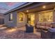 Back patio featuring a paver deck, cozy wicker furniture, and a fire pit at sunset at 17796 W Sandy Rd, Goodyear, AZ 85338