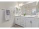 Bathroom featuring a double vanity with white cabinets and a large mirror at 17796 W Sandy Rd, Goodyear, AZ 85338