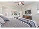 Bright bedroom with a ceiling fan, TV, and view to a secondary space at 17796 W Sandy Rd, Goodyear, AZ 85338