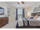 Bedroom with a TV, ceiling fan, and view to a green outdoor space at 17796 W Sandy Rd, Goodyear, AZ 85338