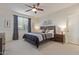 Bedroom with a ceiling fan, large window, and contemporary decorations at 17796 W Sandy Rd, Goodyear, AZ 85338