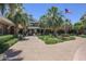 Welcoming clubhouse entrance framed by palm trees and showcasing American flags at 17796 W Sandy Rd, Goodyear, AZ 85338