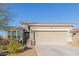 This single-story home boasts a two-car garage, desert landscaping, and mountain views at 17796 W Sandy Rd, Goodyear, AZ 85338