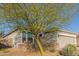 Well-maintained single-story home with desert landscaping and a two car garage at 17796 W Sandy Rd, Goodyear, AZ 85338