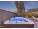 Enjoy the evening in this private back yard featuring a rejuvenating hot tub and comfortable lounge chairs at 17796 W Sandy Rd, Goodyear, AZ 85338