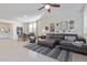 Cozy living room with modern furnishings, stylish rug, and curated wall decor, with view to dining at 17796 W Sandy Rd, Goodyear, AZ 85338