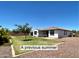 Spacious backyard with green grass, mature trees, block fencing, and a cozy outdoor seating area at 18385 W Devonshire Ave, Goodyear, AZ 85395