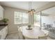 The dining area includes a white table, modern lighting, and sliding doors to the backyard at 18385 W Devonshire Ave, Goodyear, AZ 85395