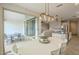 Bright dining area with an outdoor view and modern light fixture at 18385 W Devonshire Ave, Goodyear, AZ 85395